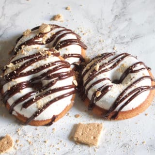 Graham cracker doughnuts topped with vanilla bean marshmallow fluff, drizzled with dark chocolate ganache topped with crushed graham crackers.
