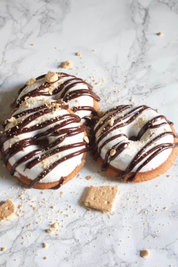  Graham cracker doughnuts topped with marshmallow fluff, drizzled with dark chocolate ganache topped with ...